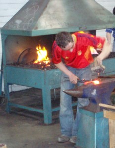 farrier making horseshoe on anvil